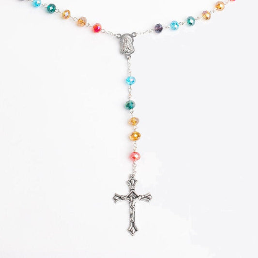 Colorful rainbow beaded rosary with a cross on a white background