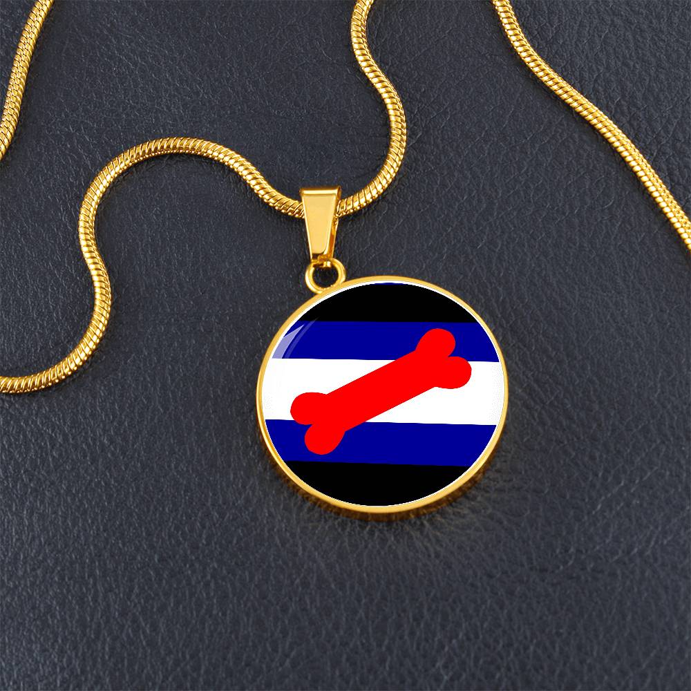 Puppy Pup Play Circle Pendant Necklace Pup-play-pendant-in-gold-on-table