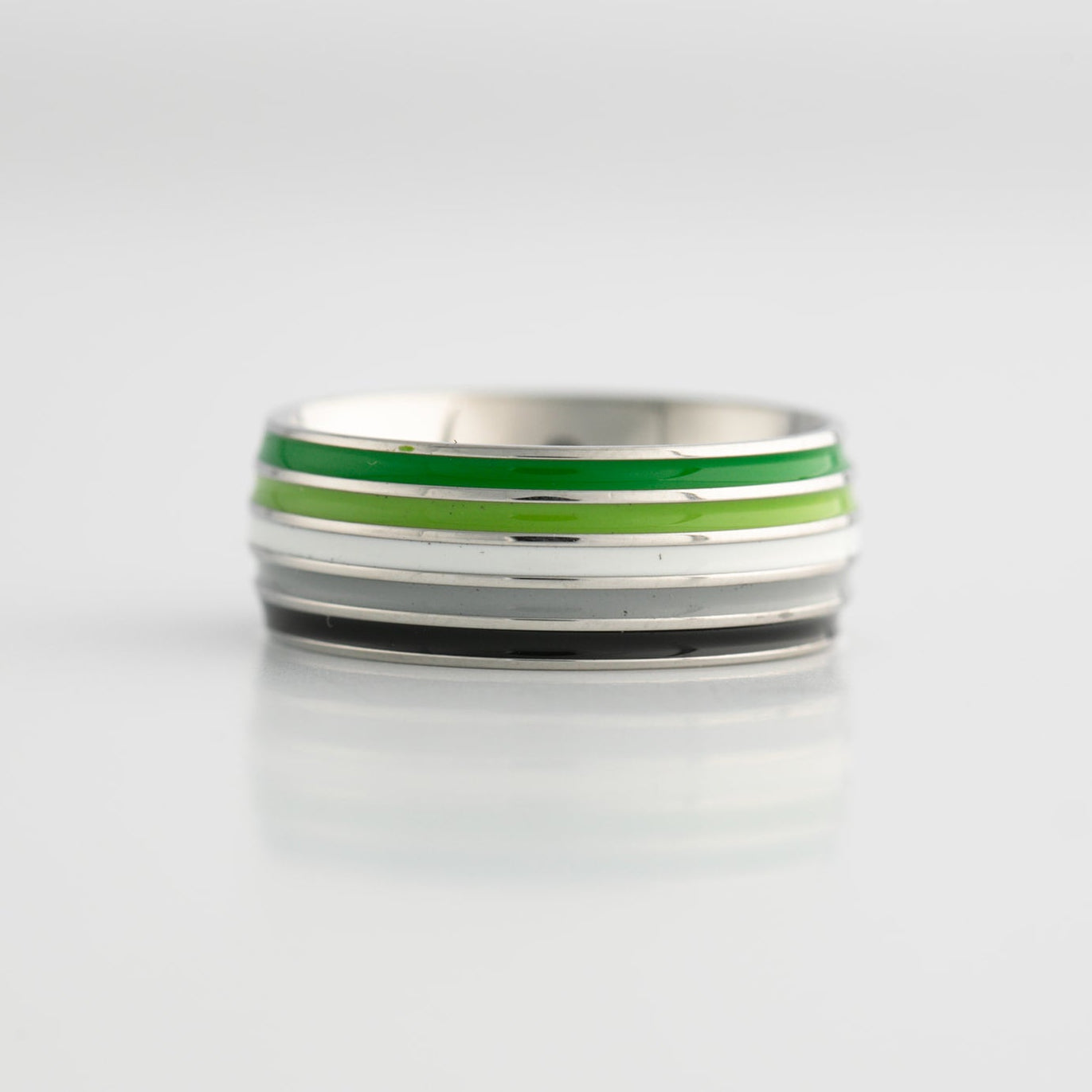 Silver ring with aromantic pride stripes on a light gray background