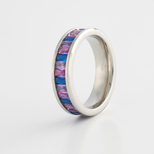 Silver ring with bi pride flag color gemstones on a white background