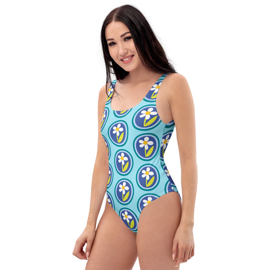 Woman wearing a blue floral patterned swimsuit on a white background