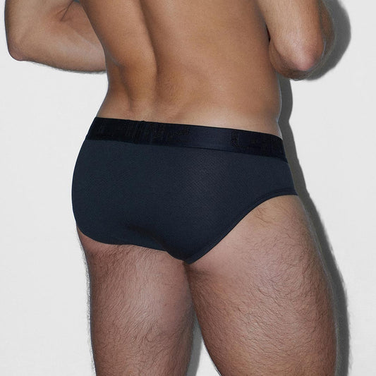 Rear view of a man wearing black briefs against a light gray background.