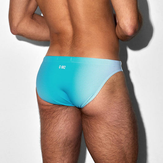 Man wearing a blue swim brief with C-IN2 branding on a white background