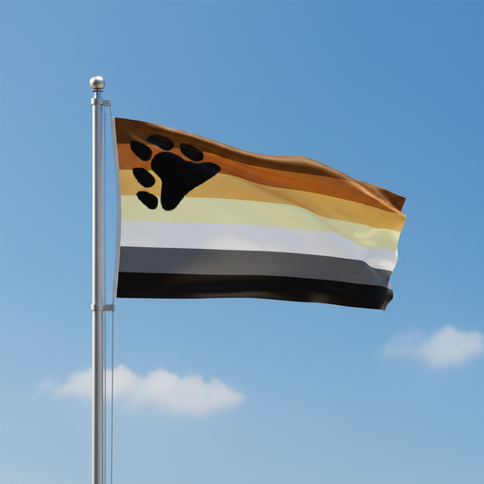A gay bear pride flag on a silver flagpole waving against a blue sky with a few clouds. The flag has horizontal stripes in brown, tan, cream, white, gray, and black, with a large black paw print in the upper left area.