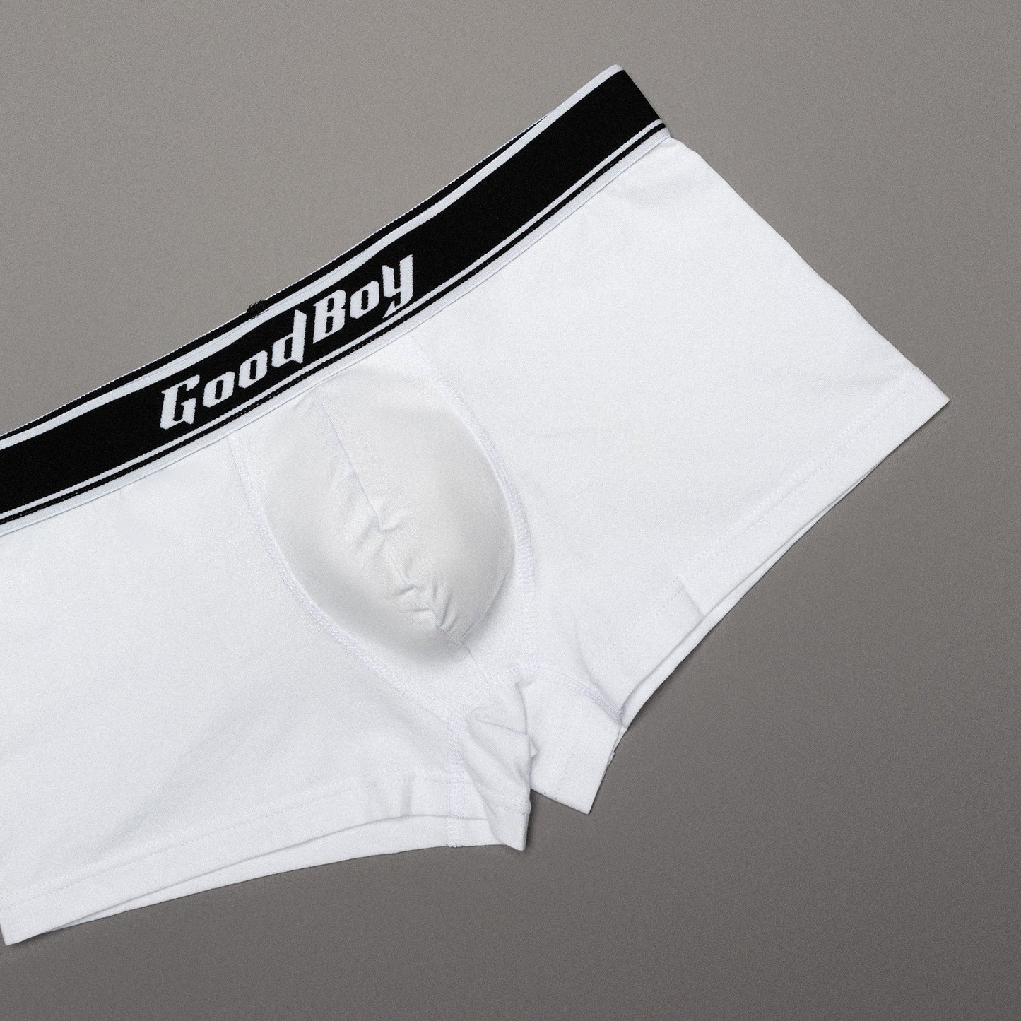 White boxer briefs with a black waistband featuring 'Good Boy' text on a gray background