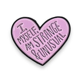 Heart-shaped pink enamel pin with "I Myself am strange and unusual' text on a white background