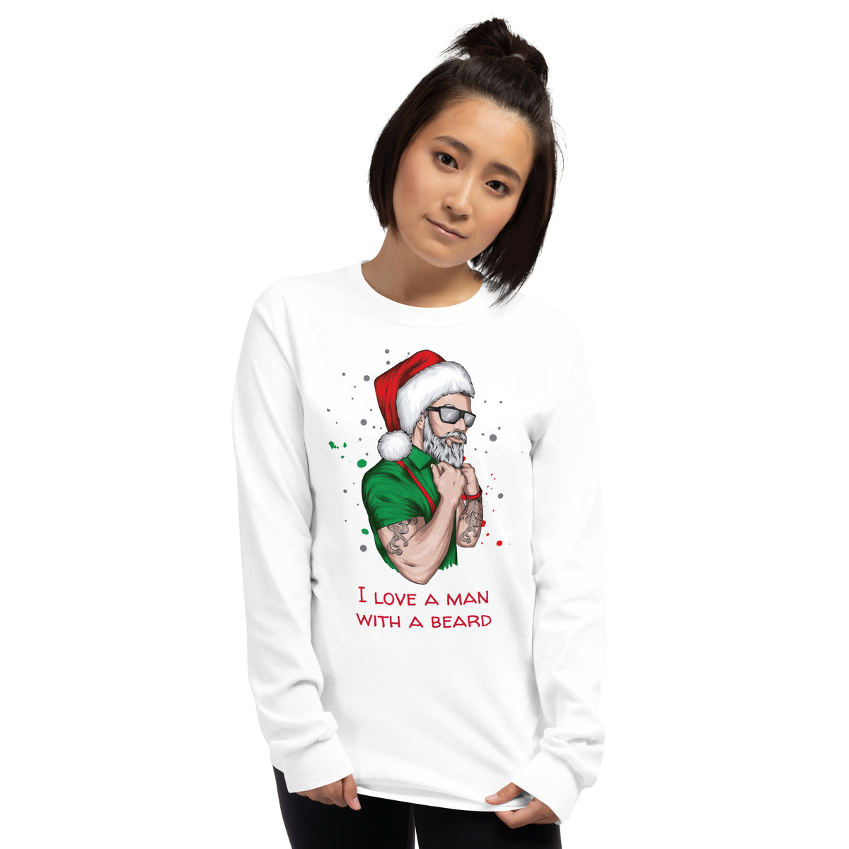 person wearing a white long sleeve shirt with an image of a lumbersexual style santa wearing a green shirt, red suspenders, traditional santa hat, sunglasses, tattoos, and dark sunglasses and text in red that reads ' i love a man with a beard'