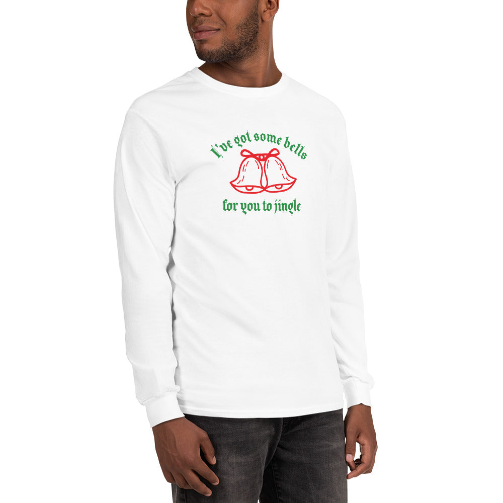 person wearing a white long sleeve shirt with green text that reads 'I've got some bells for you to jingle' and two red bells with bows