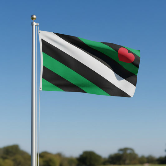 leather boy pride flag with vertical green, black, and white stripes and a red heart in the corner being flown from a flagpole against a bright blue sky