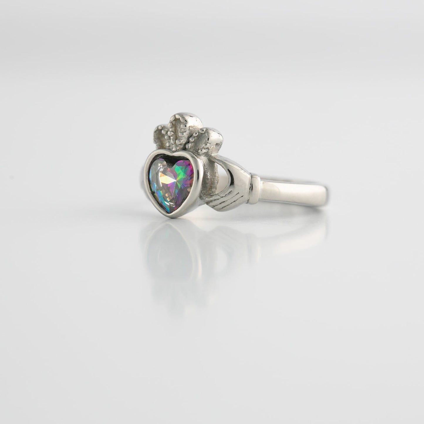 Silver ring with heart-shaped topaz gemstone with a colorful gem on a white background