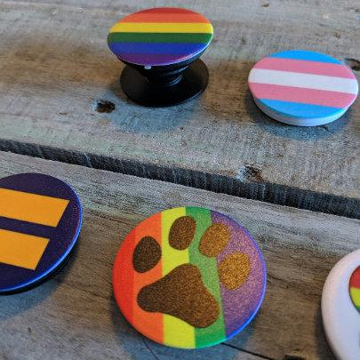 Colorful phone pop sockets on a wooden surface