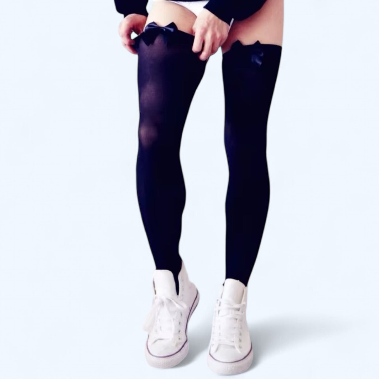 Black stockings with black bows worn by a man on a white background