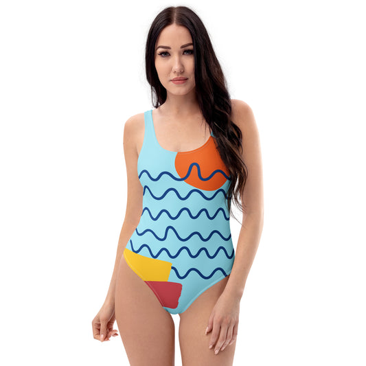 Woman wearing a colorful one-piece swimsuit with abstract patterns on a white background