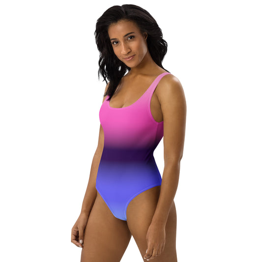 Woman wearing a omnisexual pride flag gradient swimsuit on a white background