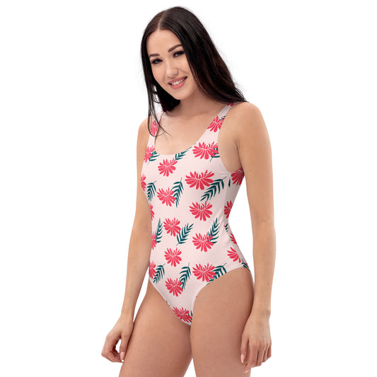 Woman wearing a pink swimsuit with a lotus floral design on a white background