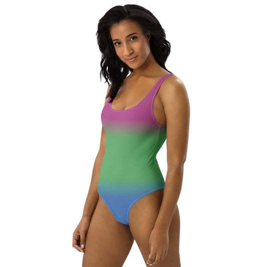 Woman wearing a polysexual pride ombre one-piece swimsuit on a white background