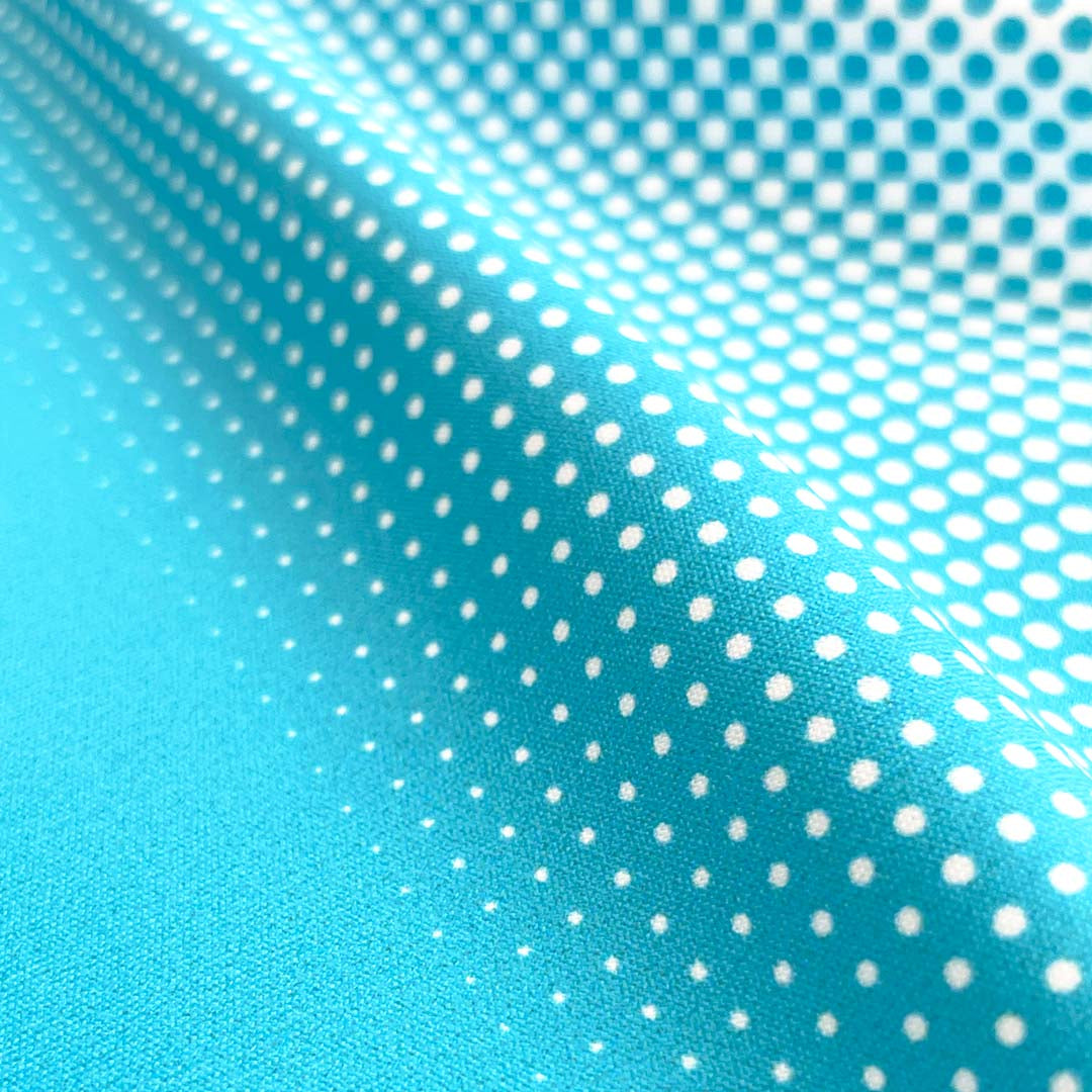Turquoise fabric with white polka dot pattern