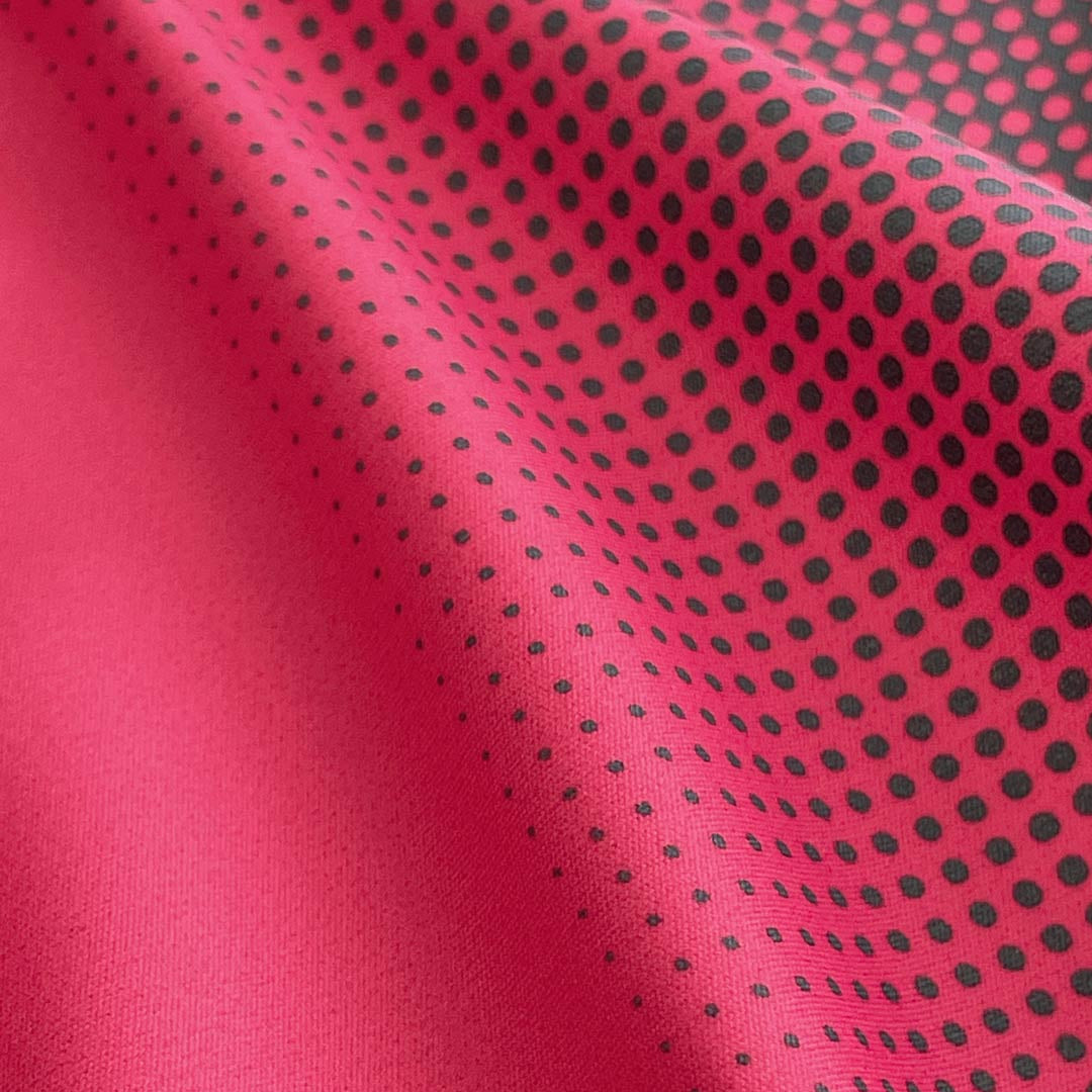 Close-up of red fabric with black dot pattern