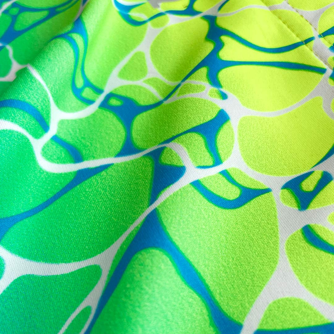 Close-up of fabric with green, blue, and white abstract pattern