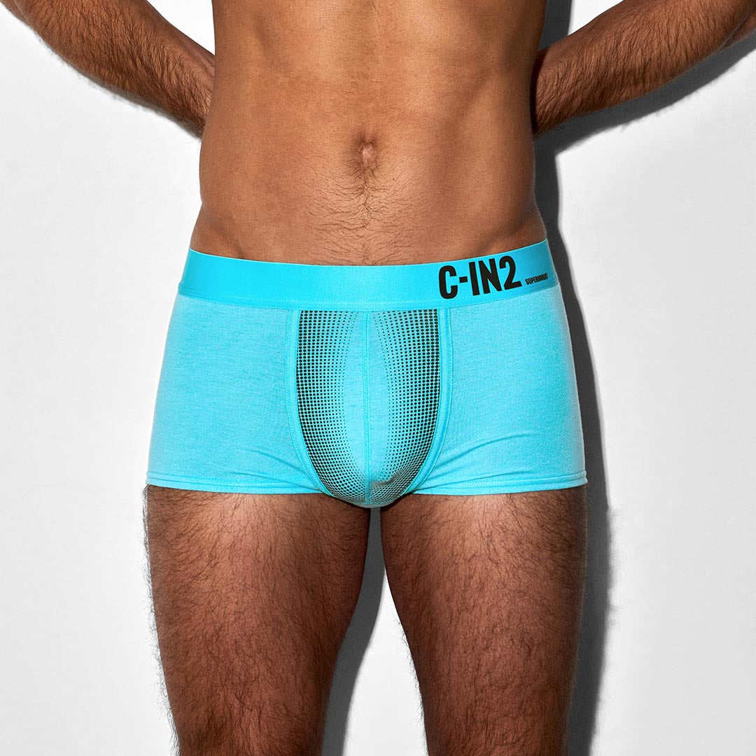 Man wearing a turquoise underwear with 'C-IN2' branding on a white background
