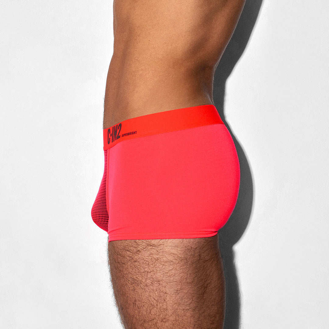 Red athletic shorts with a brand logo on a white background