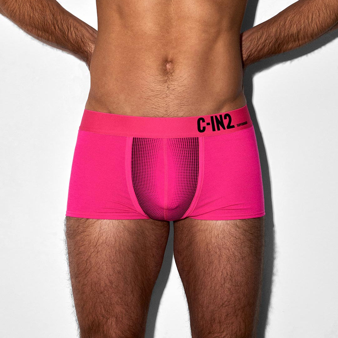 Person wearing bright pink underwear with 'C-IN2' branding on a white background