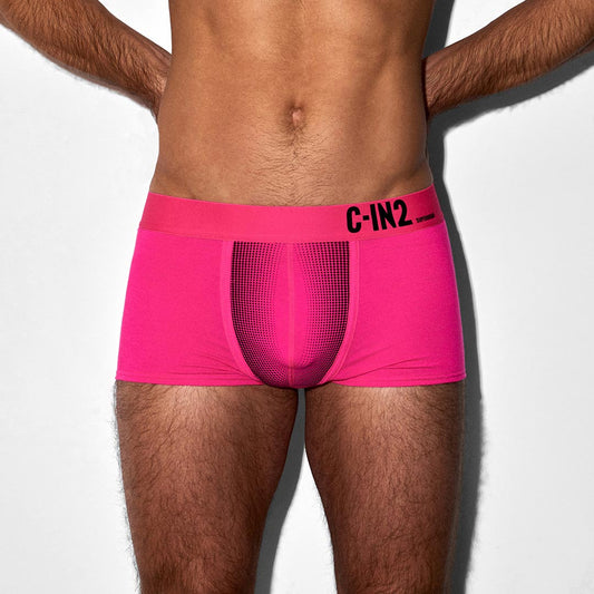 Person wearing bright pink underwear with 'C-IN2' branding on a white background