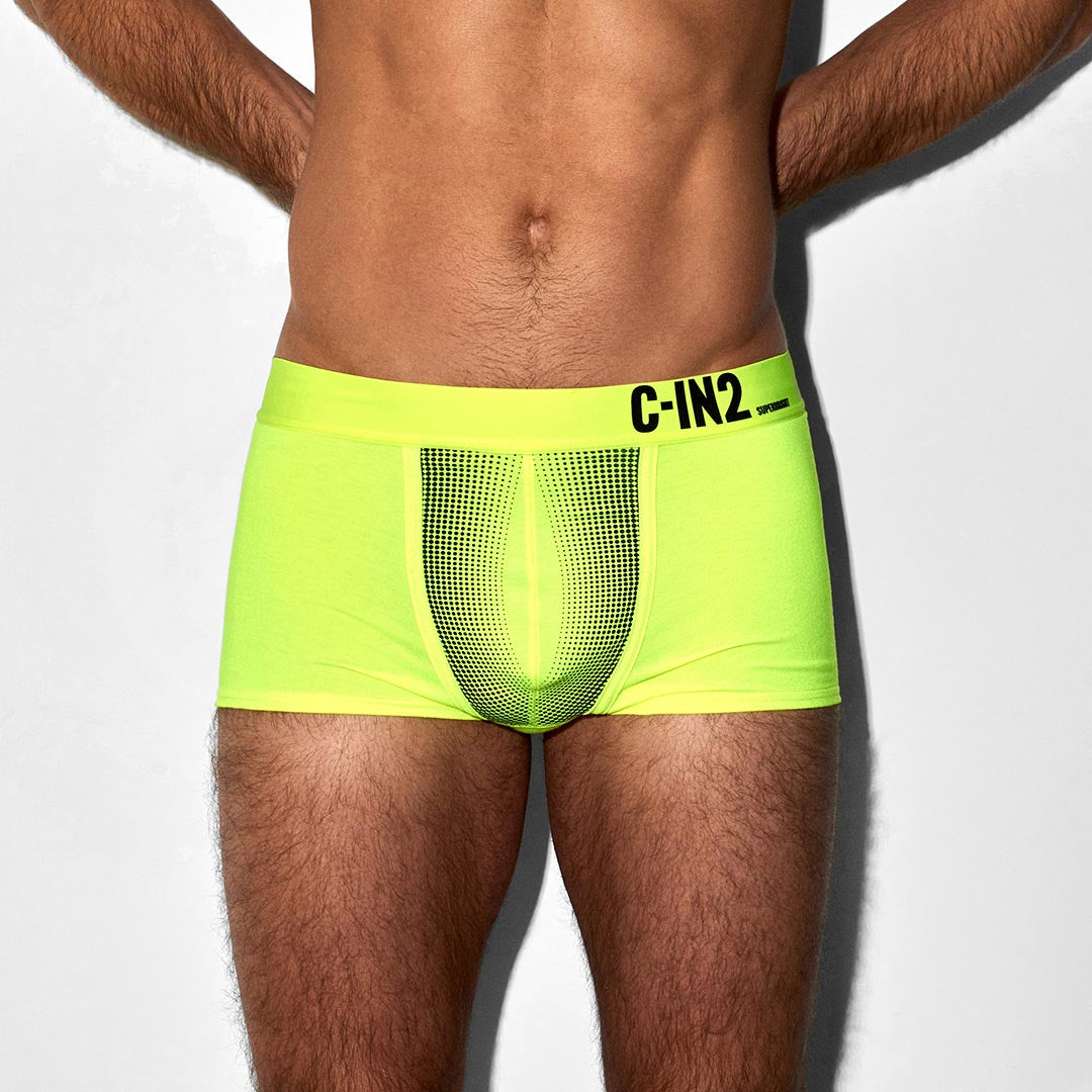 Neon green underwear with C-IN2 brand logo on a plain background