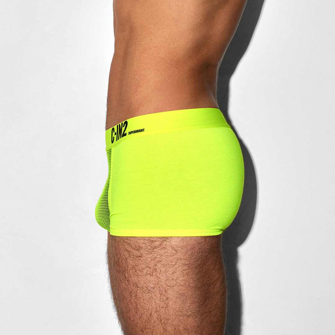 Bright green athletic shorts with brand logo on a white background