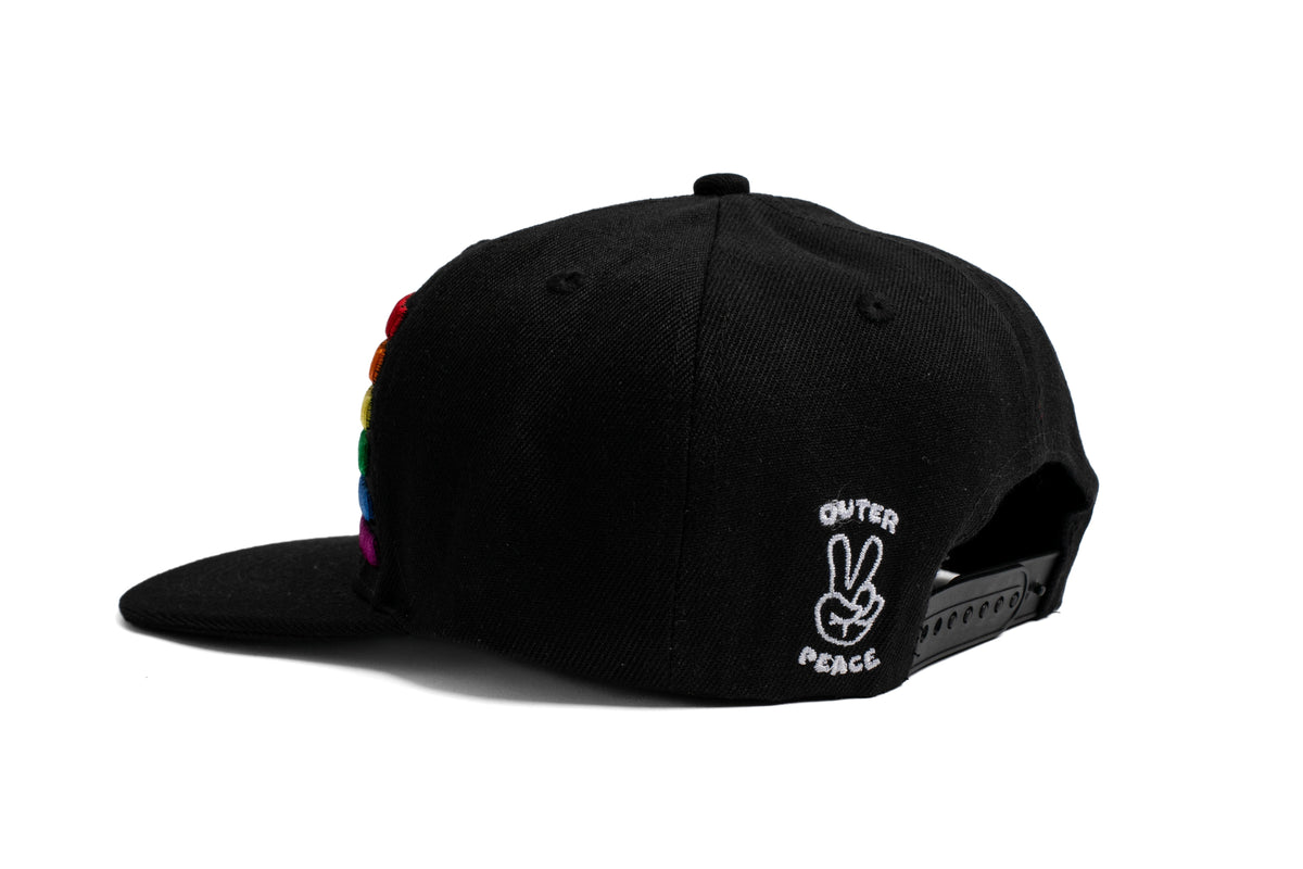 Black cap with rainbow design and peace symbol on a white background