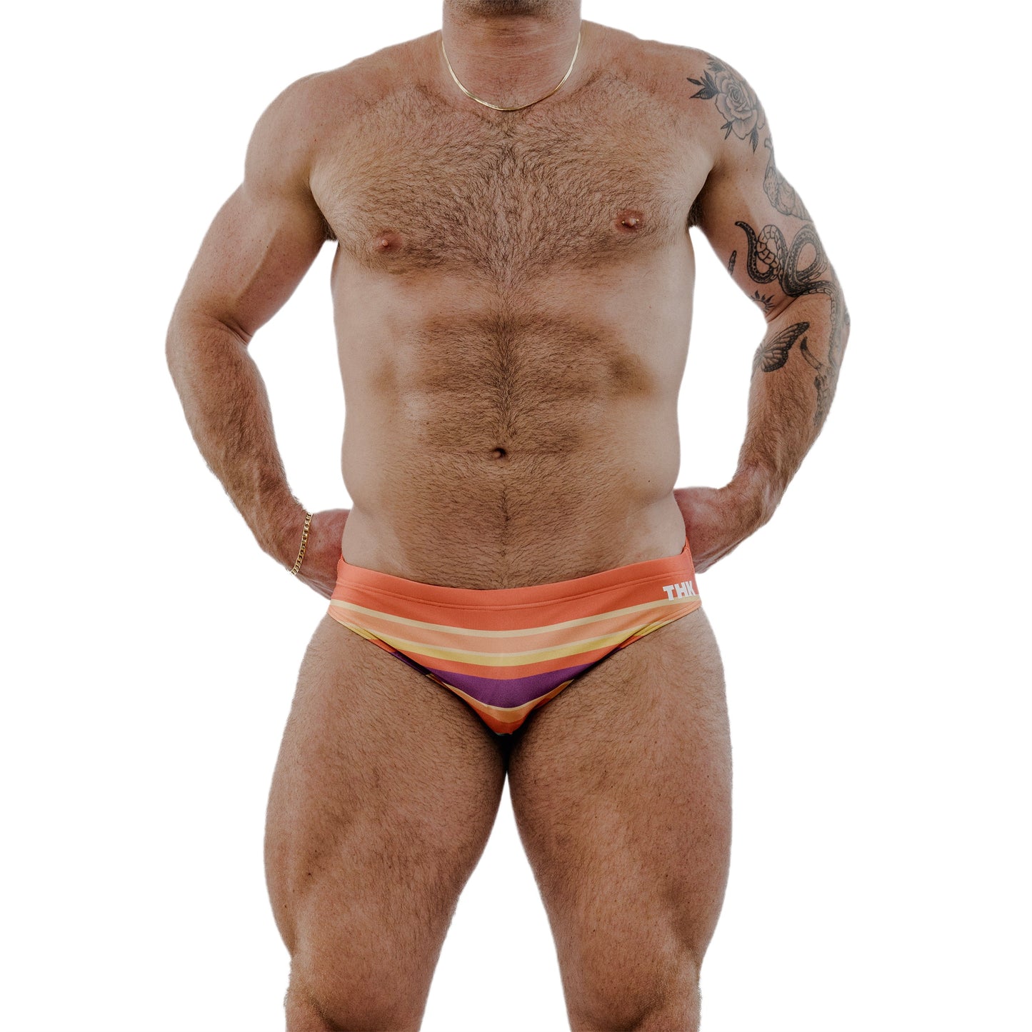 Man wearing colorful swim briefs on a white background
