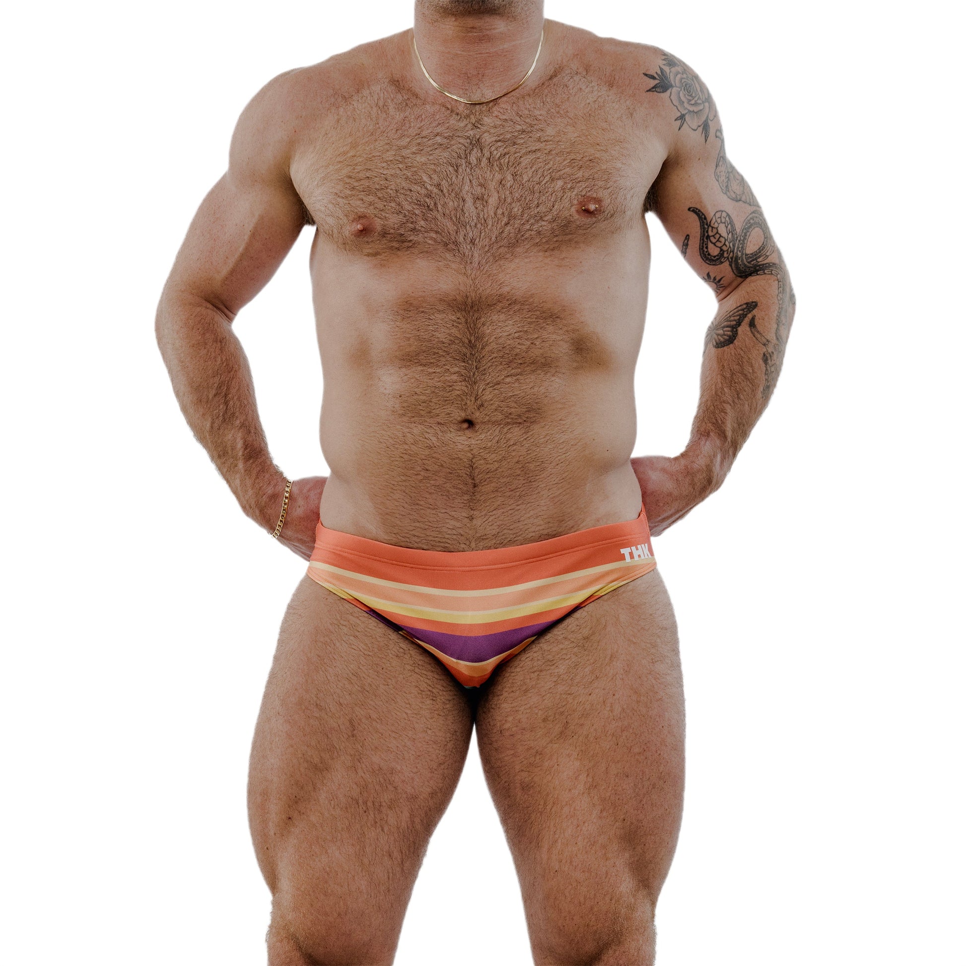 Man wearing colorful swim briefs on a white background