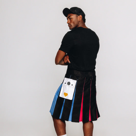 Person wearing a colorful pleated kilt with a white background