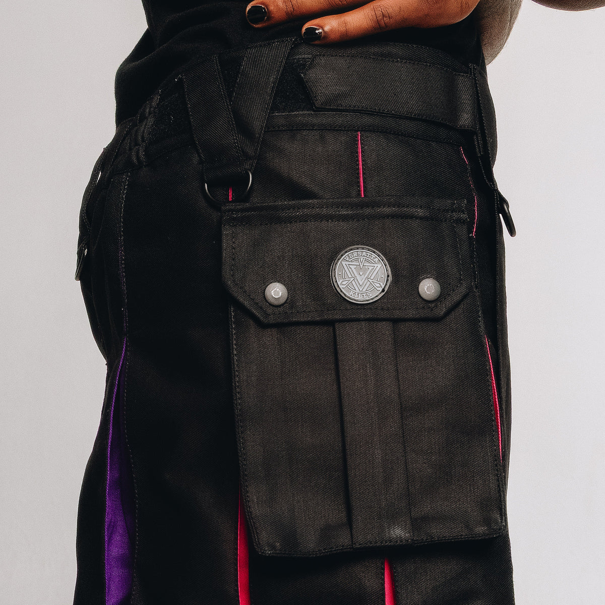 Black kilt with red and purple accents and a decorative pocket on a plain background