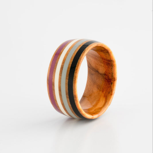 Wooden ring with ace pride inlay on a white background