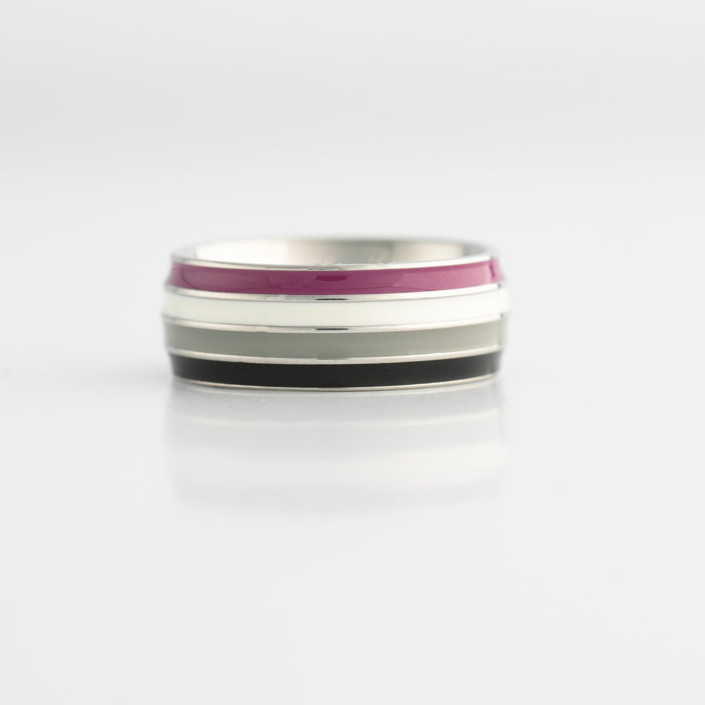 Silver ring with asexual pride flag stripes on a white background