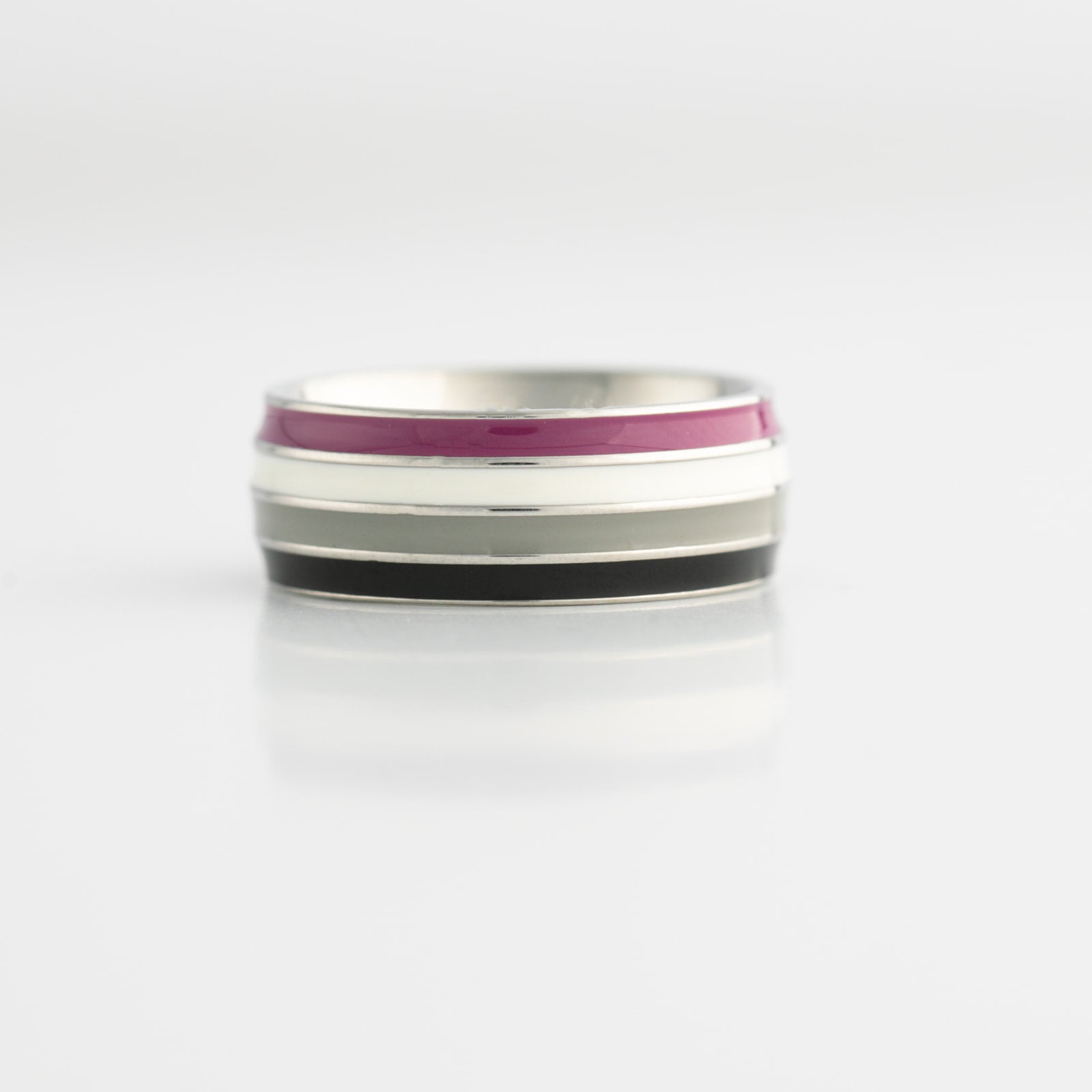 Silver ring with asexual pride flag stripes on a white background