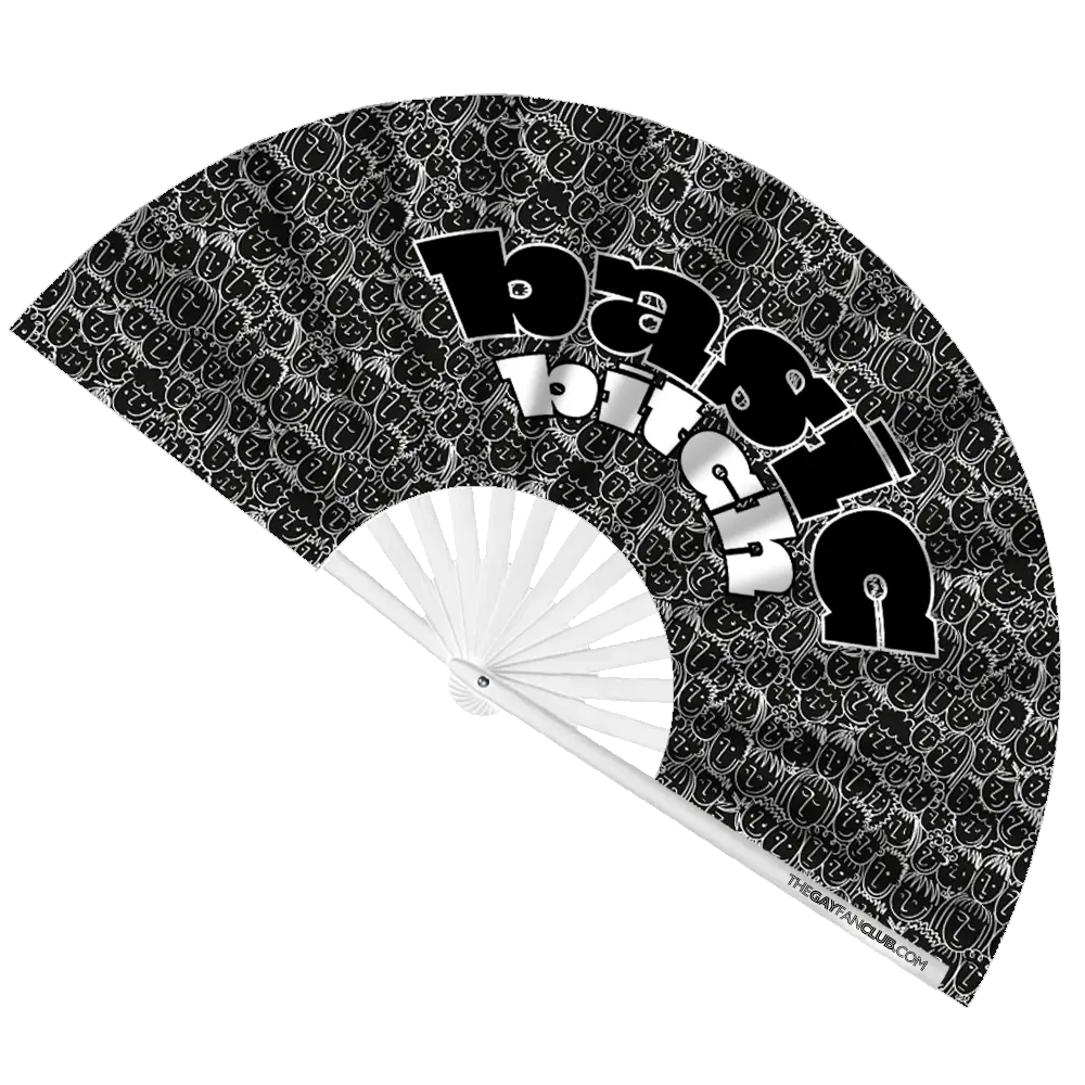 Black and white patterned hand fan with text 'Basic Bitch' and visible brand name on a white background
