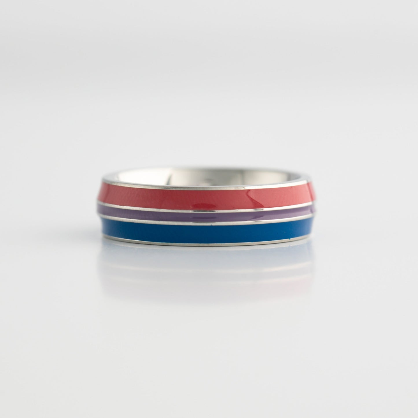 Bisexual pride ring with red, blue, and purple stripes on a white background