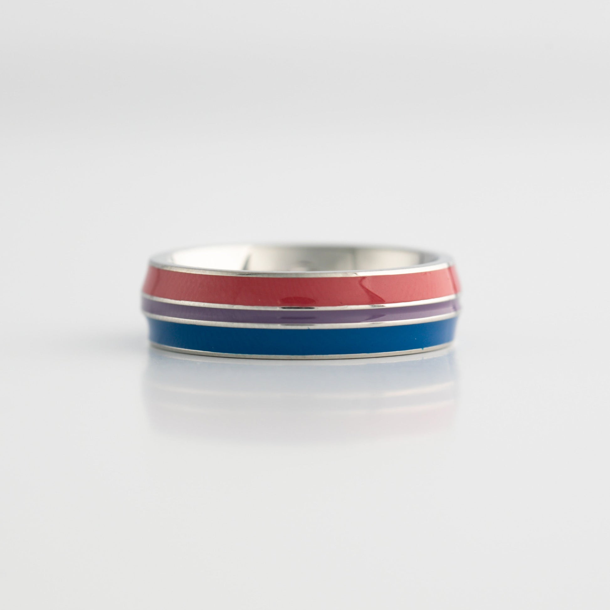 Bisexual pride ring with red, blue, and purple stripes on a white background