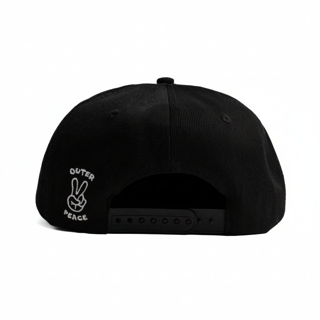 Black snapback cap shown from the back, featuring a small white embroidered graphic on the side with the text 'OUTER PEACE' and a peace sign.