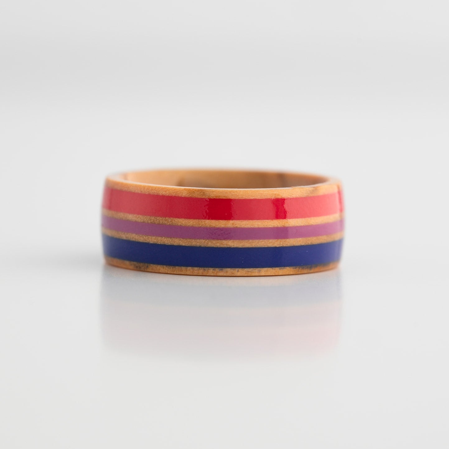 Bi Pride ring with red, blue, and purple stripes on a white background
