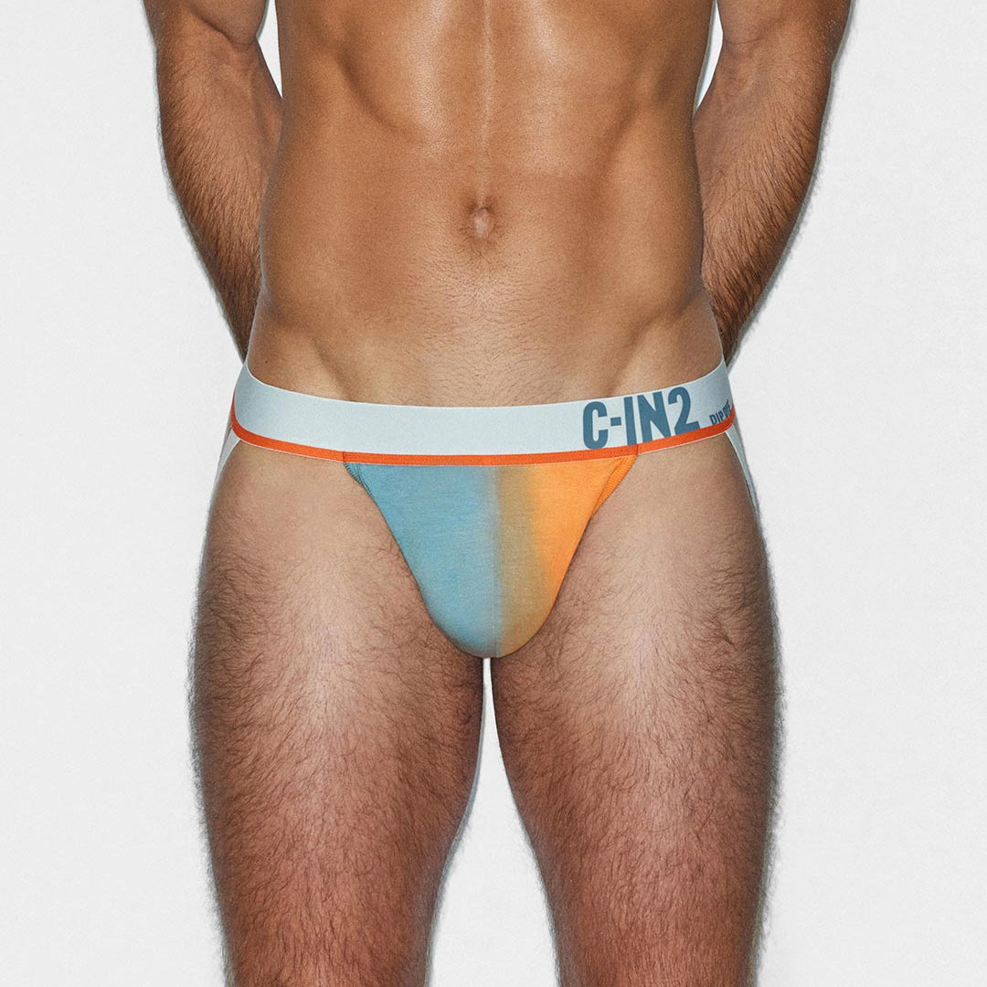 Man wearing a colorful men's jockstrap with 'C-IN2' branding on a white background