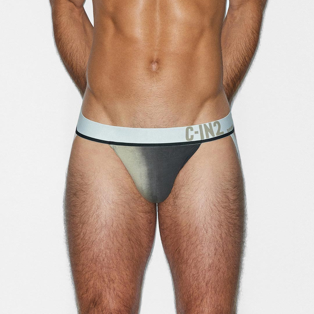 Man wearing a black and beige men's jockstrap with 'C-IN2' branding on a white background