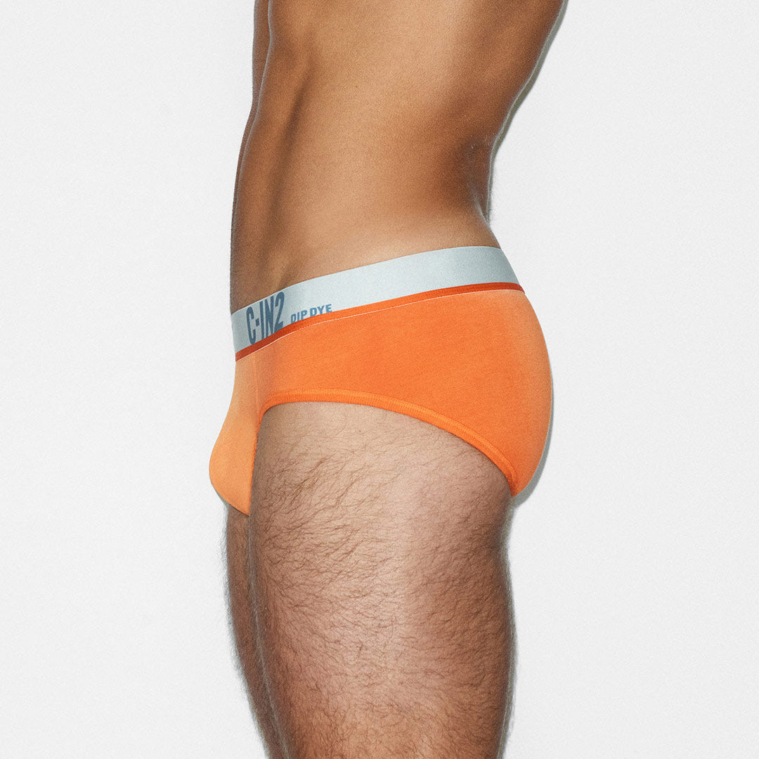 Orange men's underwear with a brand label on a white background
