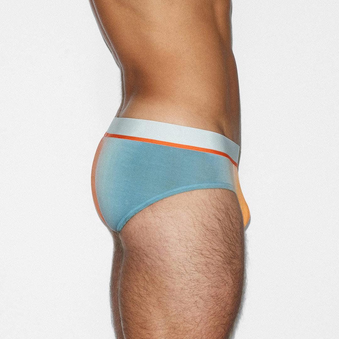 Light blue men's underwear with orange waistband on a white background