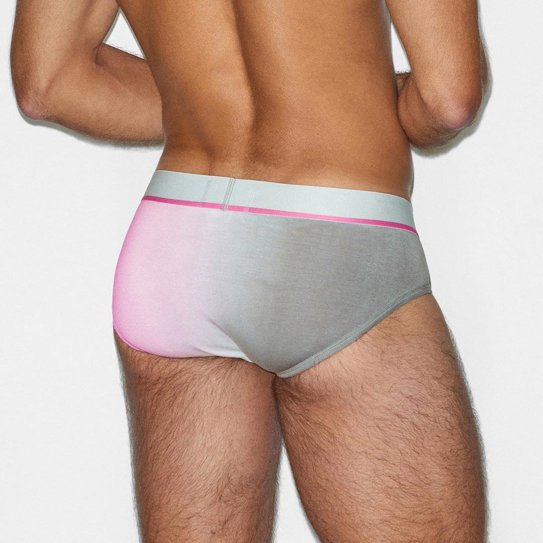 Man wearing a gray and pink underwear set on a white background