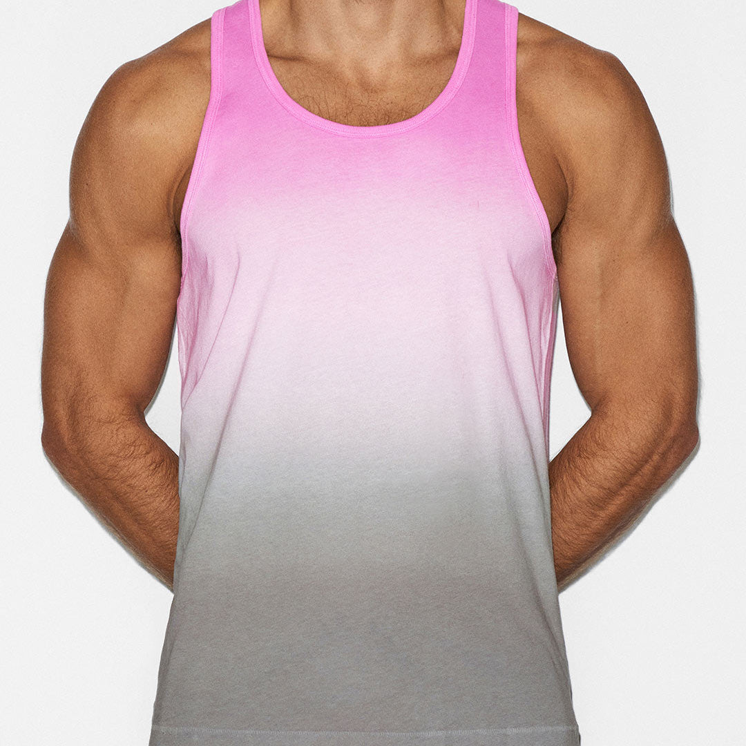 Person wearing a pink and gray gradient tank top on a white background