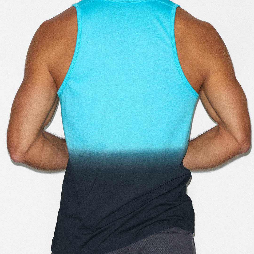Person wearing a blue gradient tank top on a white background