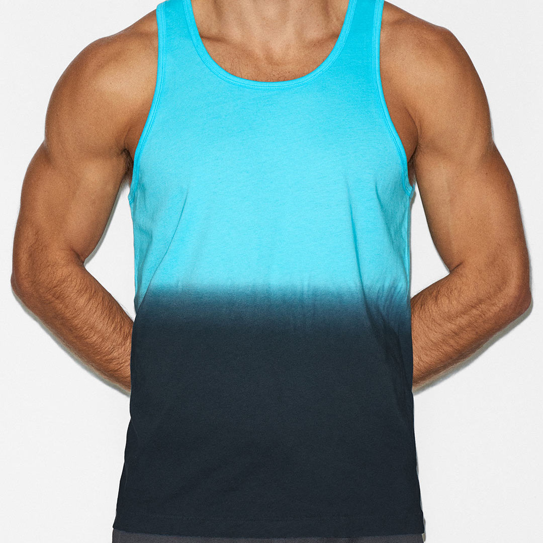 Person wearing a blue gradient tank top on a white background